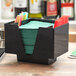 A black Choice bar caddy with green napkins and straws.