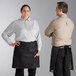 A man and woman wearing black Acopa Kennett bistro aprons with black webbing.