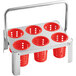 A metal rack with 6 red perforated cylinders on it.