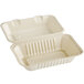 A white bagasse take-out container with a lid open.