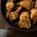 Regal Tarragon Leaves seasoning on chicken in a skillet.