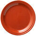 A close-up of a red Libbey Cantina melamine plate with a white background.