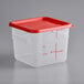 A translucent square plastic food storage container with a red lid and handle.