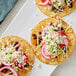 A tortilla with black beans, radishes, onions, and V&V Supremo Queso Fresco cheese crumbles.