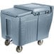 A large grey plastic Cambro mobile ice bin with sliding lid on wheels.