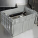 A grey plastic Vollrath Tote 'N Store chafer box with metal containers inside.
