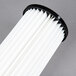 A close-up of a white and black HEPA filter for Hoover Hush 15" Upright vacuums.