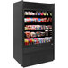 A black Structural Concepts Micromarket Refrigerator with different types of food on shelves.