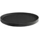 A black Choice oval non-skid serving tray with black round plates on it.