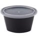 A black Pactiv oval plastic souffle container with a clear lid.