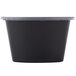 A black oval plastic souffle container with a clear plastic lid.
