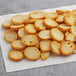 A pile of Meliora Traditional Mini Bruschette Toast crackers on a white surface.