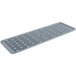 An OXO Good Grips grey rectangular silicone drying mat with a grid pattern and a grey plastic strip with holes.