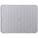 An OXO Good Grips white silicone drying mat with a grid pattern.