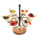 A Tablecraft black powder-coated steel and acacia wood cone holder with fruit in cones on it.