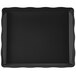 A black rectangular tray with a scalloped edge.