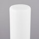 A white plastic cylinder with a lid.