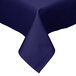 A navy blue square Intedge tablecloth with a folded edge on a white table.