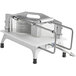 A Vollrath Redco Tomato Pro 3/8" Tomato Slicer with a metal frame and scalloped blades on a counter.