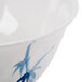 A close-up of a blue and white Thunder Group Blue Bamboo melamine bowl with a swirl design.