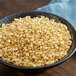 A bowl of Pop Weaver white butterfly popcorn kernels.
