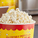 A bucket of Pop Weaver Butterfly Popcorn kernels with a label that says freshly popped.