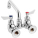 A silver Waterloo wall-mounted faucet with two red knobs.