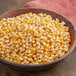A bowl of Pop Weaver gold butterfly popcorn kernels.