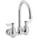 A silver Waterloo wall mount faucet with red handles.