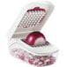 An OXO vegetable chopper with a red onion inside.