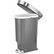 A close-up of a simplehuman gray trash can with the lid open.
