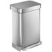 A silver metal simplehuman rectangular step-on trash can with a lid.