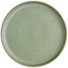 A close up of a sage green Acopa Pangea porcelain plate.