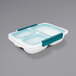 An OXO white rectangular polypropylene food storage container with a blue divided lid.