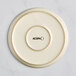 A white Acopa Pangea coupe porcelain plate with a circle on it.
