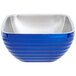 A cobalt blue Vollrath metal bowl with a stainless steel handle.