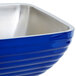 A cobalt blue Vollrath square beehive bowl with a stainless steel rim.