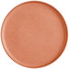 An Acopa Pangea Terra Cotta matte coupe porcelain plate with a round shape and orange color.