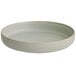 An Acopa Pangea ash matte porcelain pasta bowl with a white rim on a white surface.