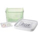 An OXO white rectangular plastic container with a green basket and lid.