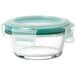 An OXO Good Grips clear glass round container with a green snap-on lid.