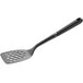 An OXO Good Grips black nylon perforated turner with a handle.