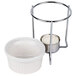 An American Metalcraft white ceramic ramekin with a metal stand over a lit candle.