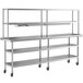 A Regency stainless steel expeditor table with double overshelf and undershelves on wheels.
