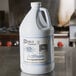 A white jug of Noble Chemical Actifoam Restroom Cleaner with a blue label.