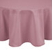 A pink Intedge round cloth table cover on a table.