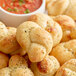 Europastry garlic knots on a plate with dipping sauce.