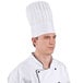 A man wearing a white Chef Revival European chef hat.