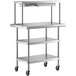 A stainless steel Regency work table with shelves on wheels.