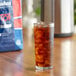 A glass of iced tea with ice on a table next to a bag of Lavazza Top Class Filtro Whole Bean Filter Coffee.